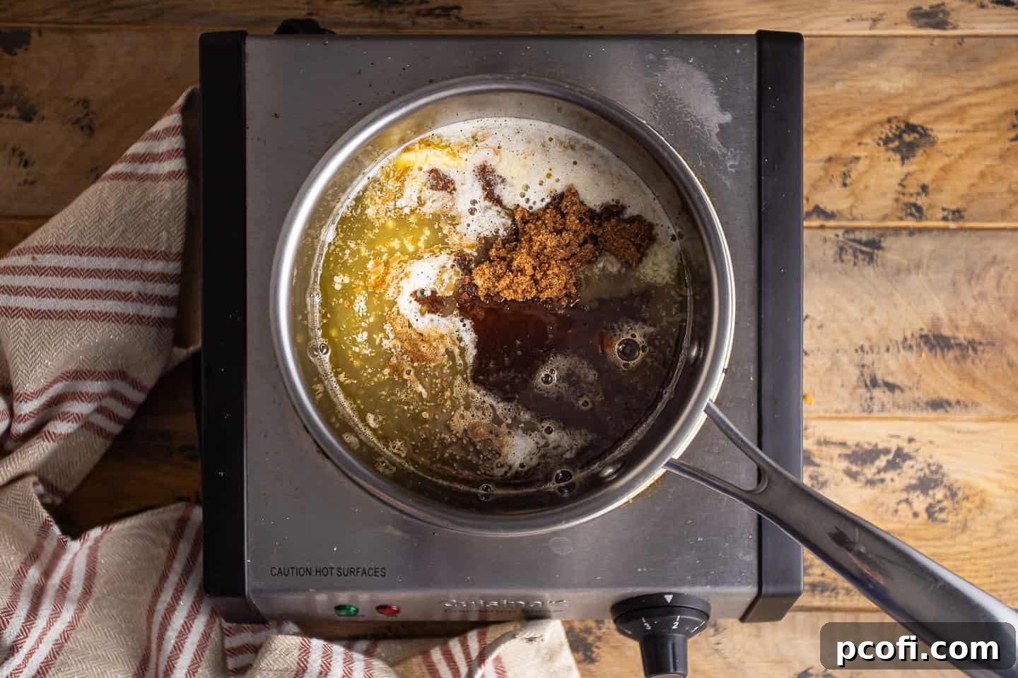 Ingredients for making rum glaze: melted butter, brown sugar, and rum, combined in a small pot.