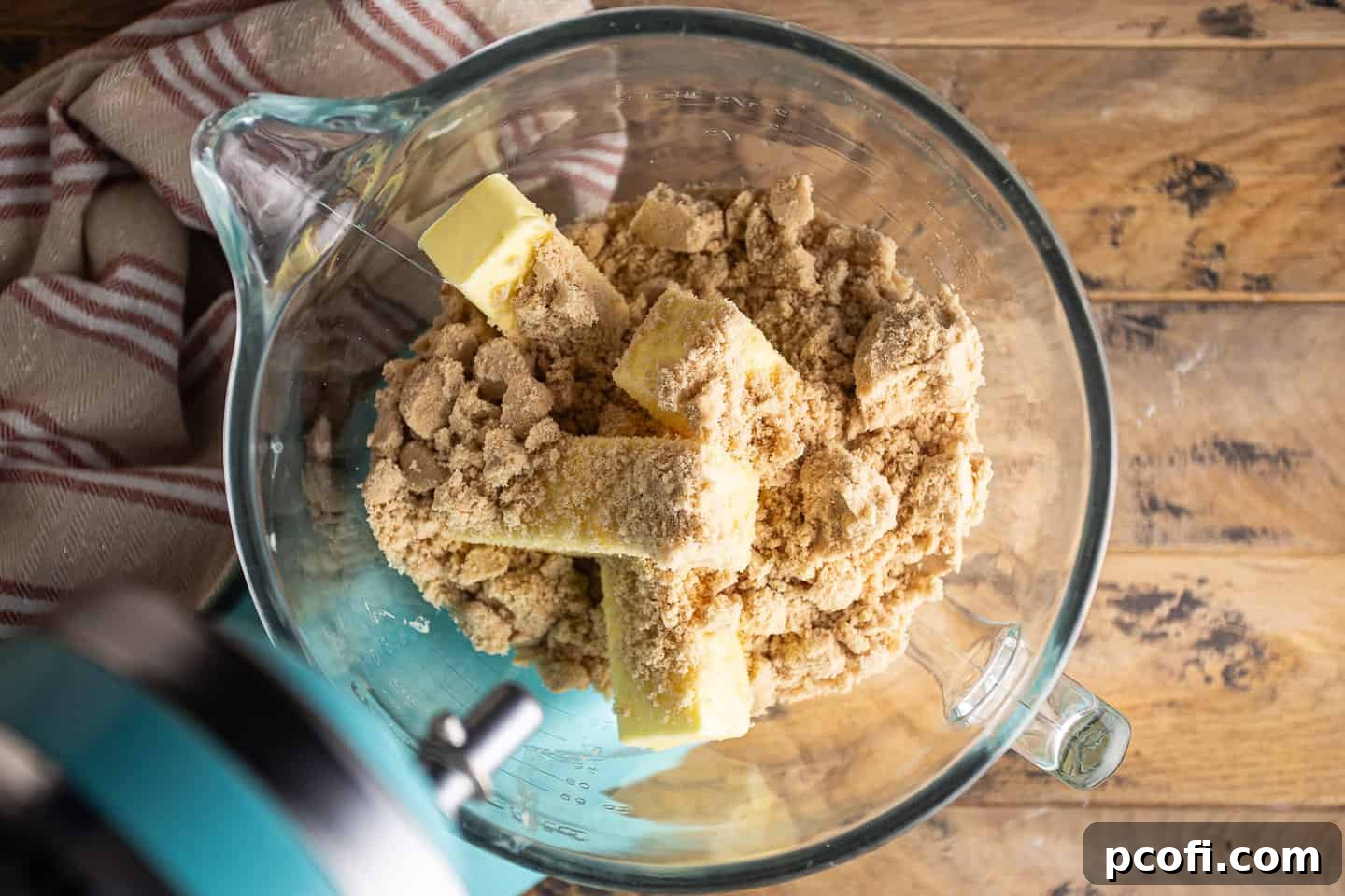Softened butter and light brown sugar, ready to be creamed in an electric mixer bowl.