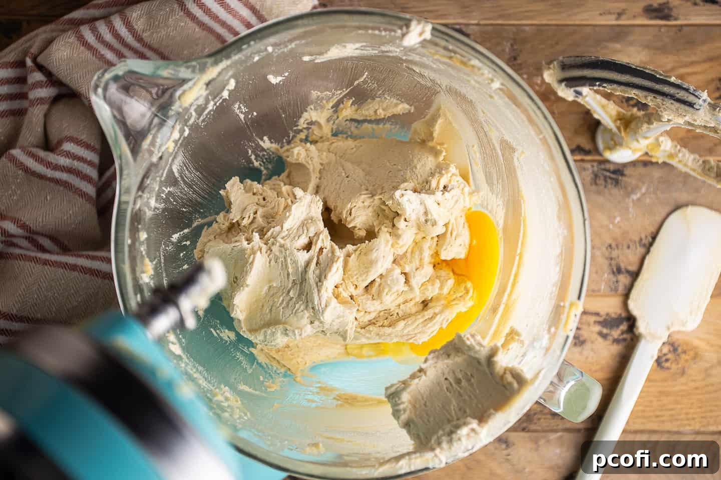 Creamed butter and brown sugar mixture with a single egg added, ready for incorporation.