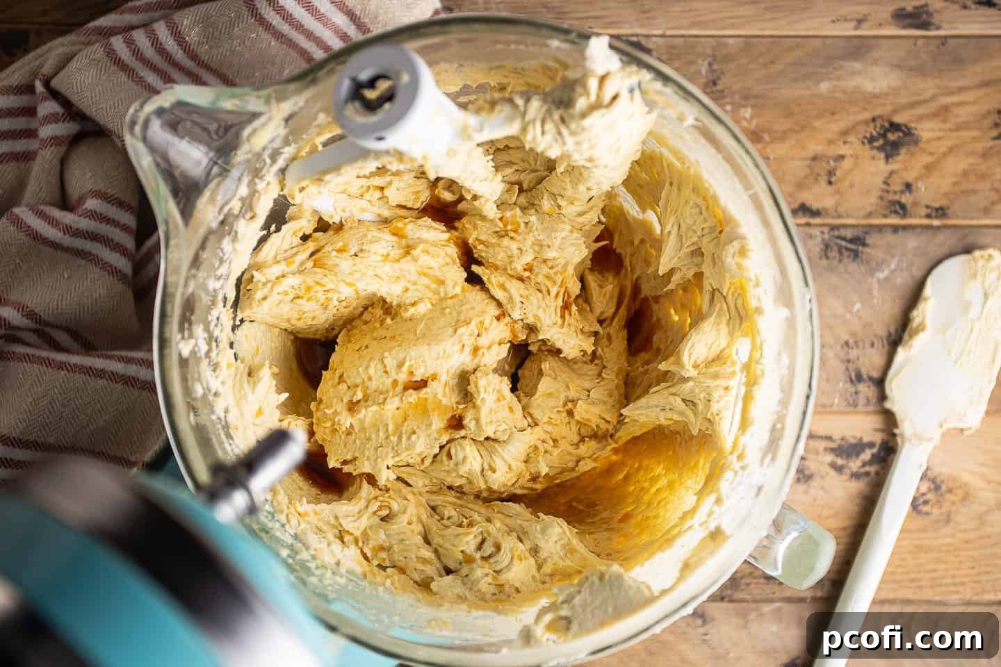 Adding liquid ingredients like rum and vanilla to the rum cake batter, infusing it with flavor.