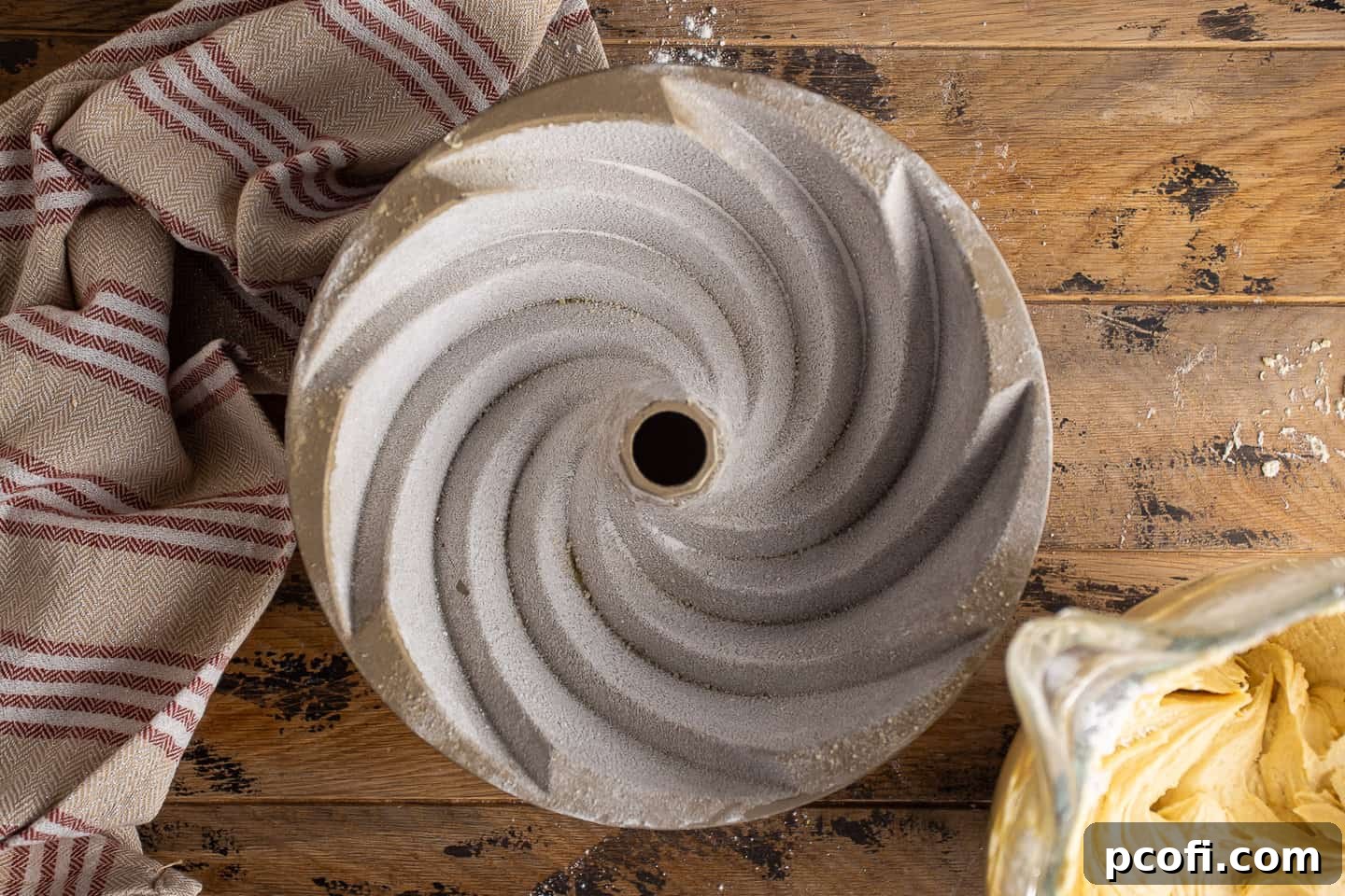 A bundt pan, generously greased and floured, ready for the rum cake batter.