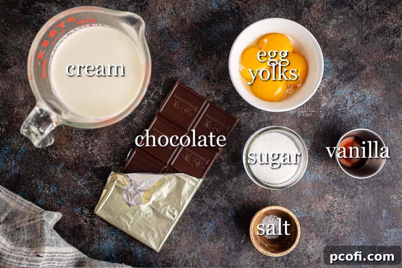 A perfectly arranged display of all the essential ingredients needed for crafting decadent pot de creme, each clearly labeled for easy identification.