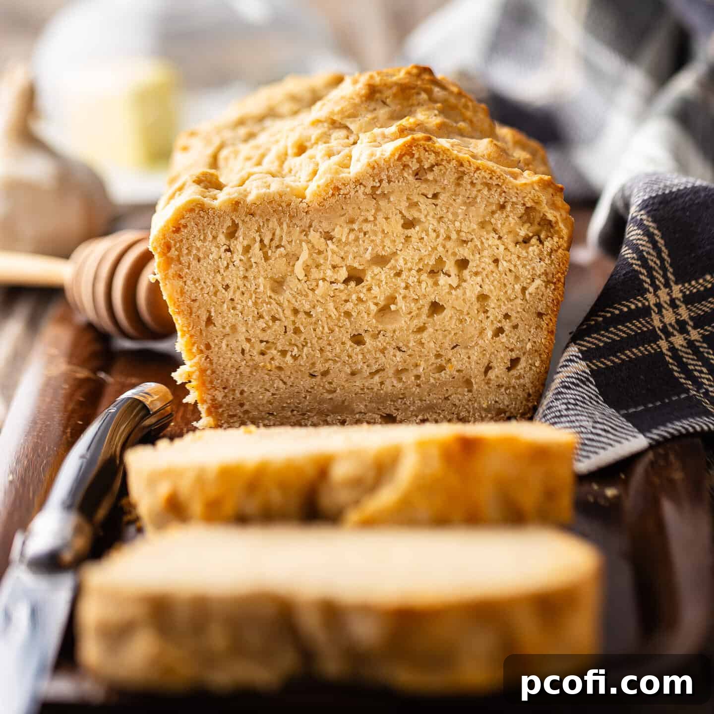 Beer bread recipe, baked and presented on a wooden tray.
