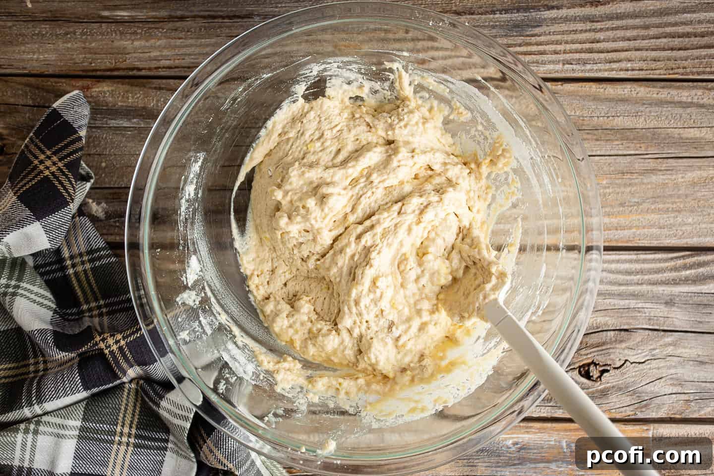 Gently folding beer bread dough until combined.