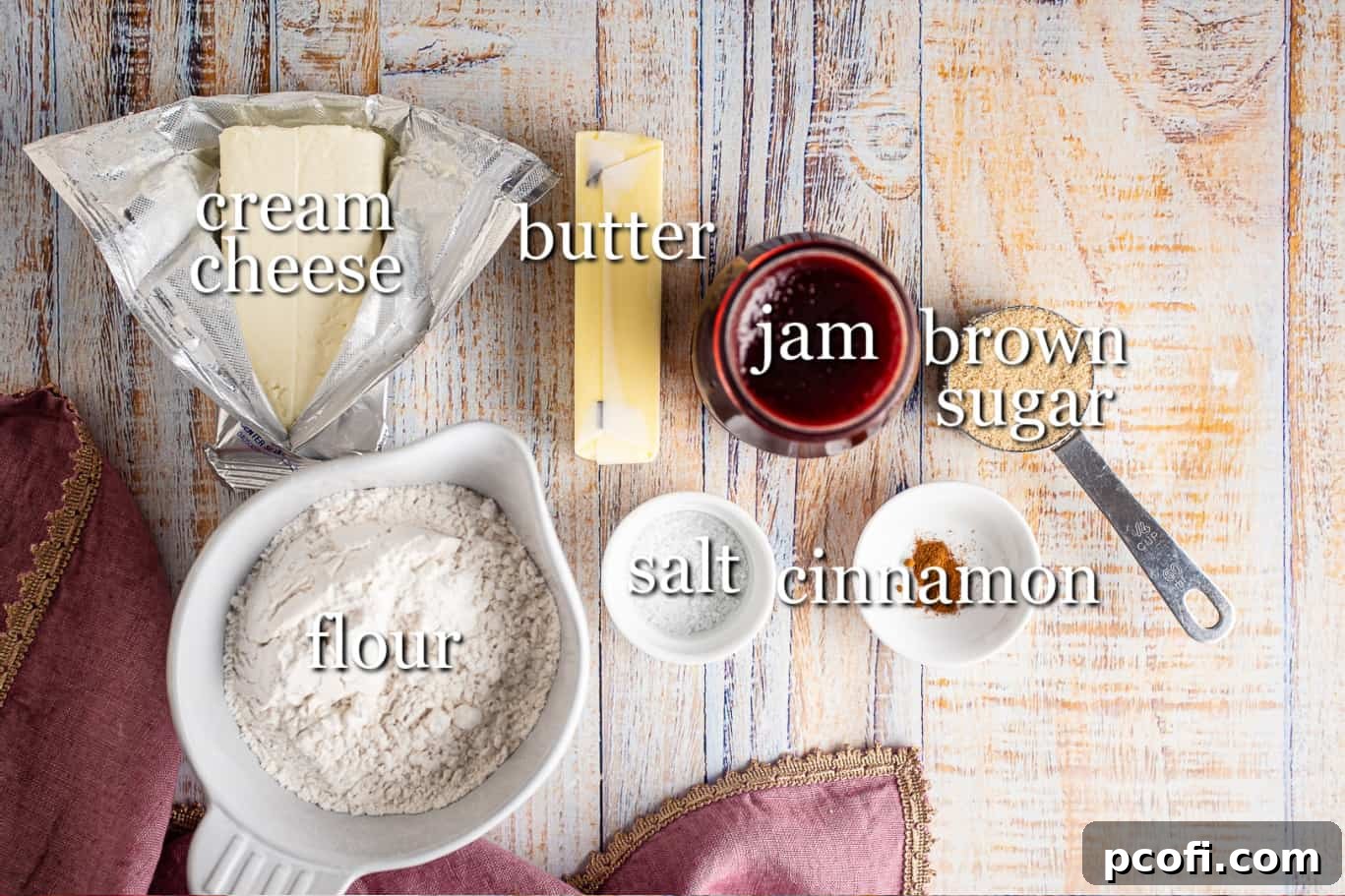 Ingredients for raspberry tarts neatly arranged on a counter with text labels.