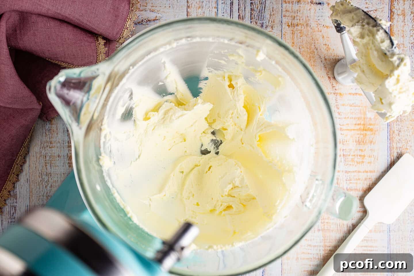 Softened butter and cream cheese blended together in a stand mixer bowl, looking creamy and smooth.