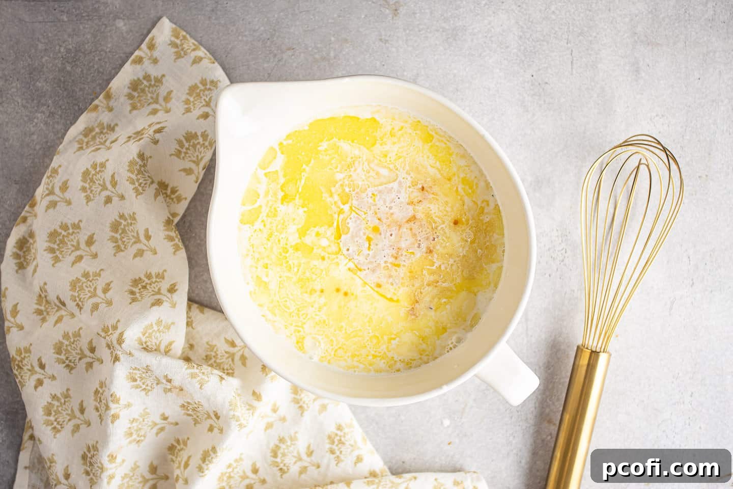 Bread pudding custard ingredients in a large spouted bowl.