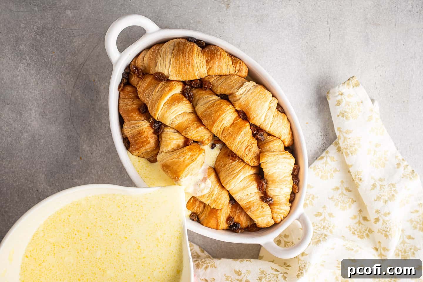Pouring custard over croissants.