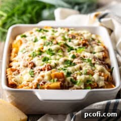 Baked rigatoni in a white casserole dish.