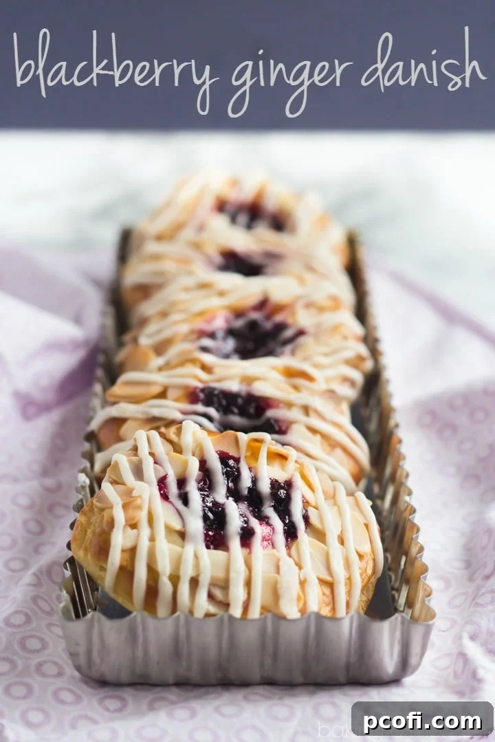 Close-up of a Blackberry Ginger Danish, showcasing the flaky pastry layers, rich blackberry ginger filling, and delicate vanilla bean glaze.