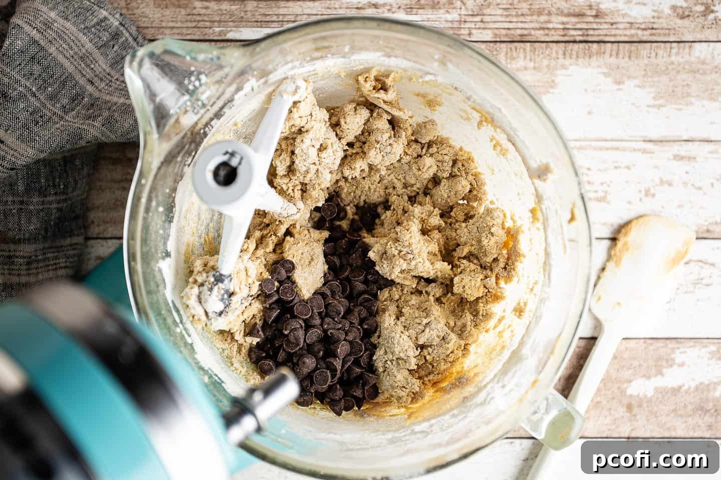 Folding chocolate chips into the skillet cookie dough until just combined.