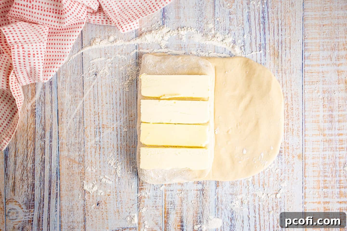 Dough folded over the first butter layer, with the second butter layer placed on top.