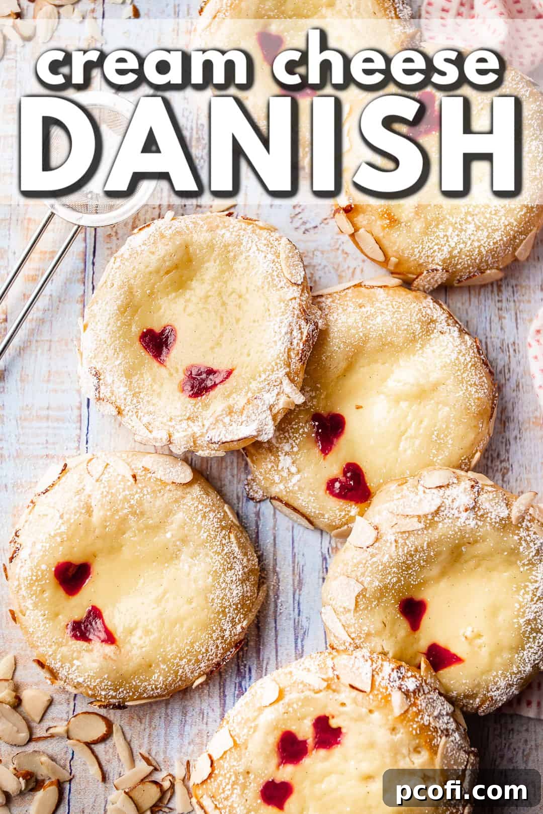 Beautifully baked Cheese Danish pastries, garnished with sliced almonds and a dusting of powdered sugar.