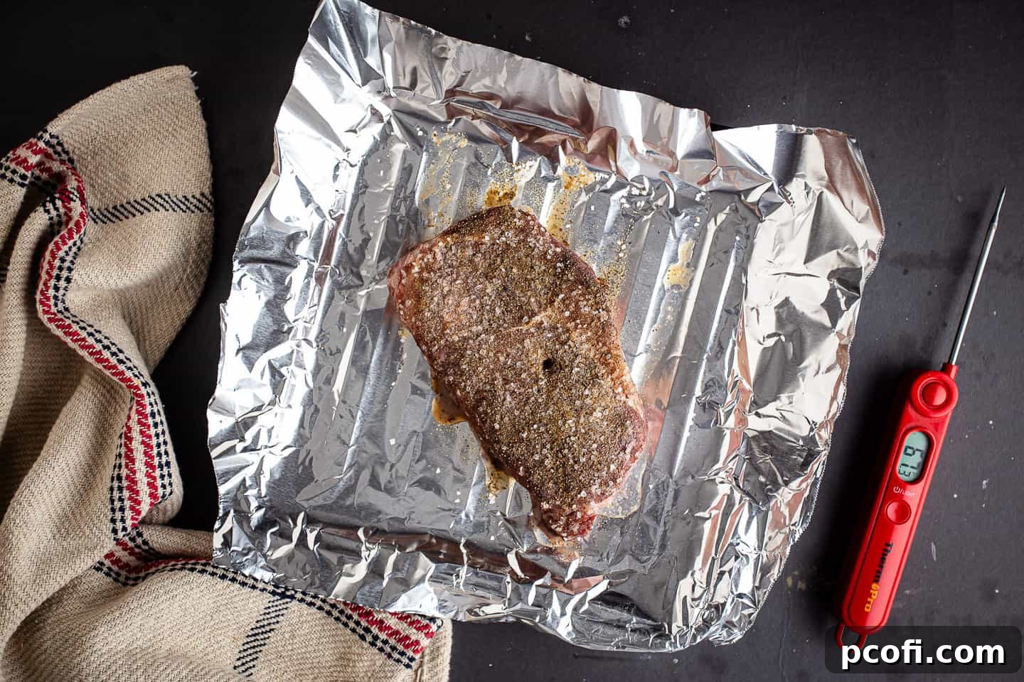 A seasoned steak that's been partially cooked in a low oven.