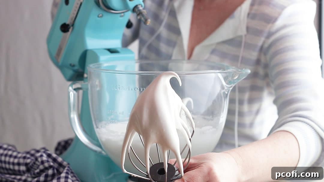 Stiff, glossy meringue whipped to perfection, holding its peaks firmly, ready to crown the lemon pie.