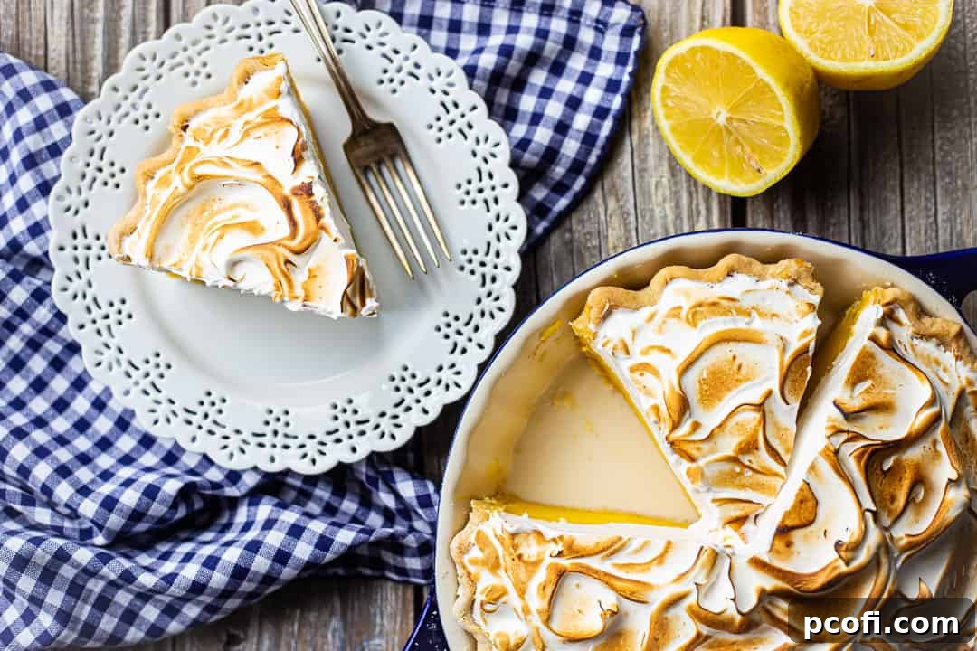A freshly toasted lemon meringue pie, showcasing beautifully browned peaks and soft valleys, ready to be served.