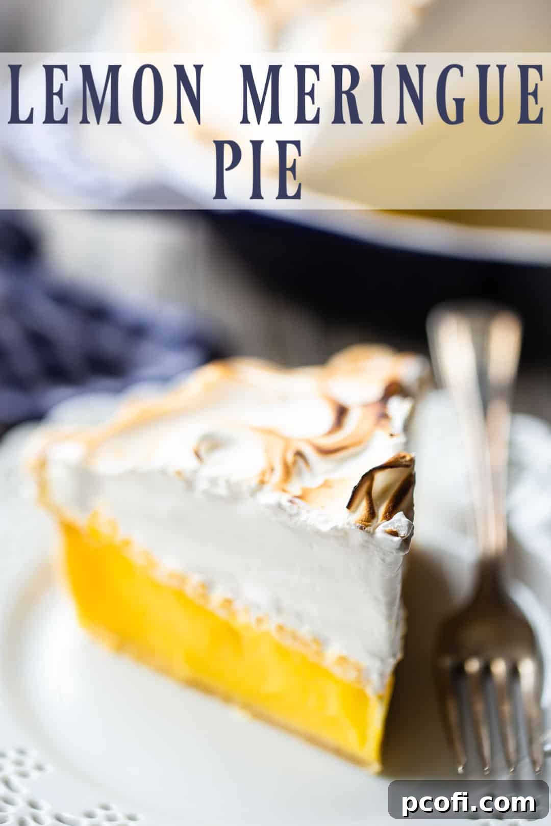 A whole lemon meringue pie with a beautifully toasted, mile-high meringue topping, ready for serving.