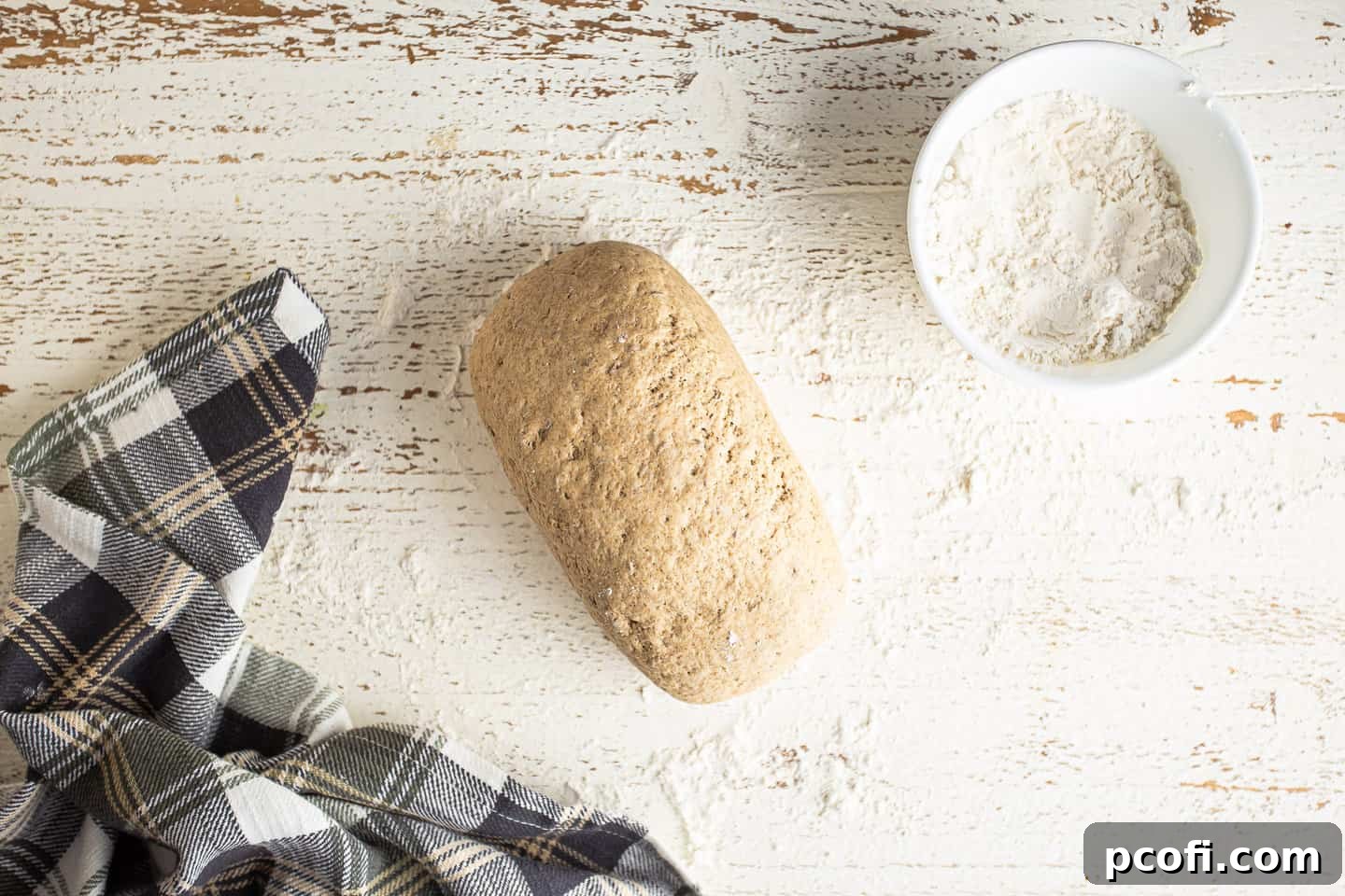 Shaping rye bread dough into a loaf.