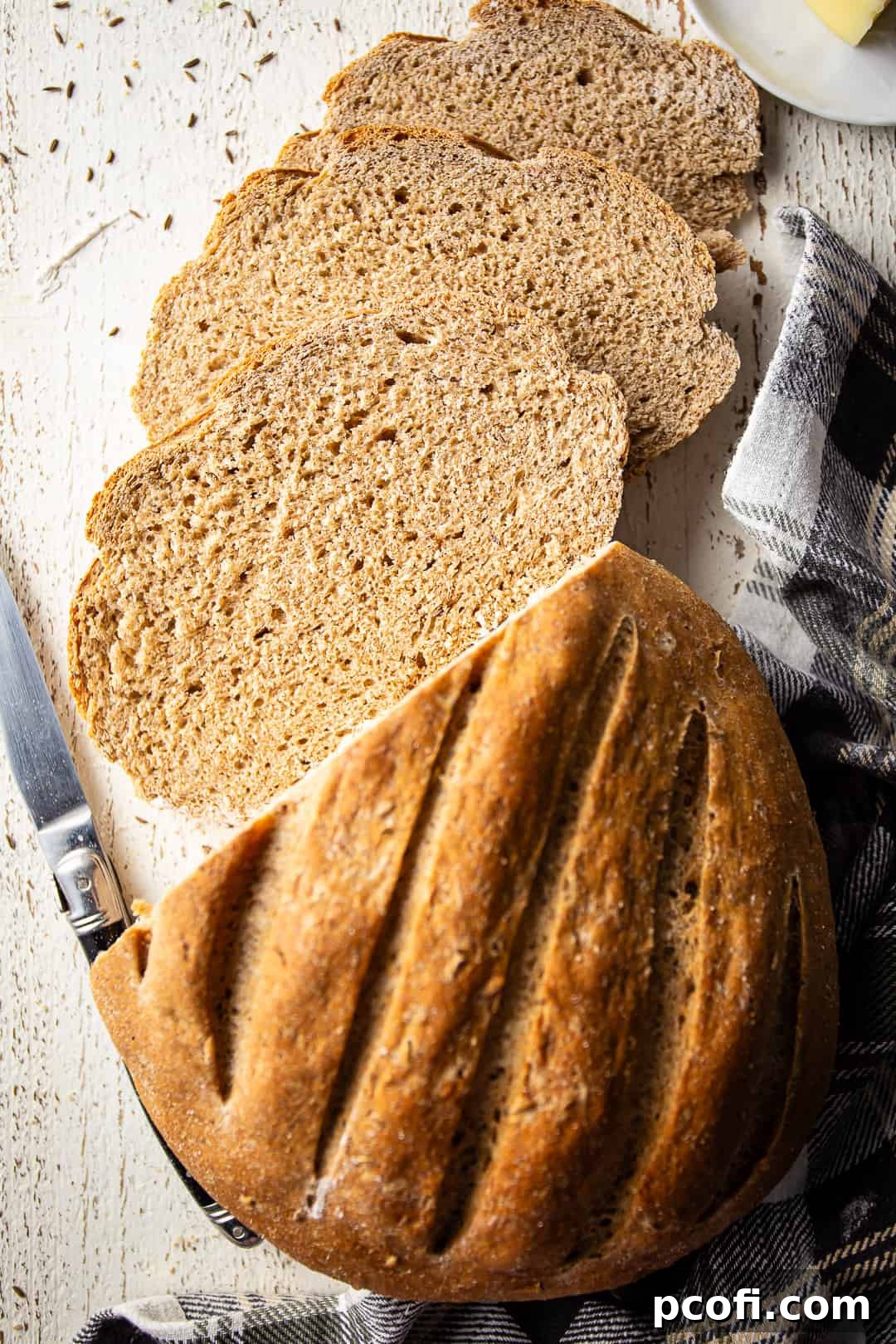 Bread with rye baked into a loaf and sliced for sandwiches or toast.