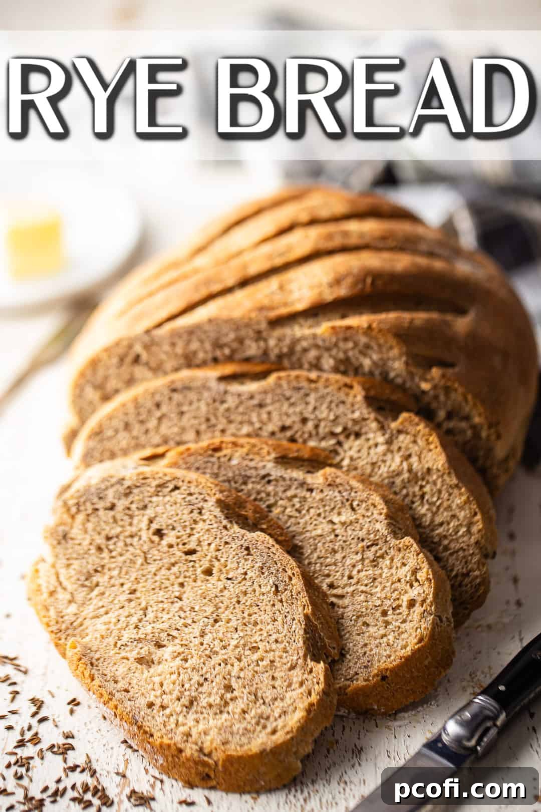 Rye bread recipe baked, sliced, and displayed with a plaid cloth.
