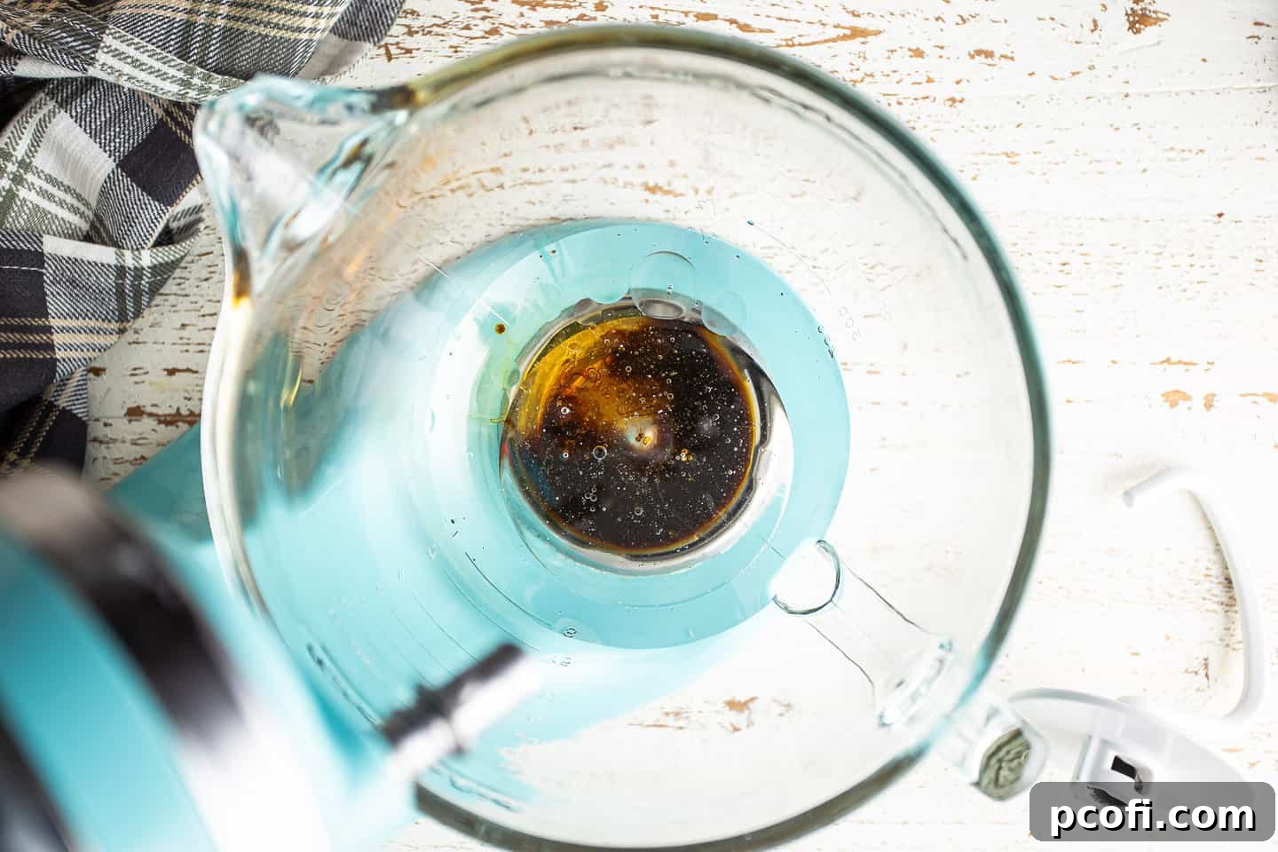 Warm water, oil, molasses, and honey in the bowl of a stand mixer.