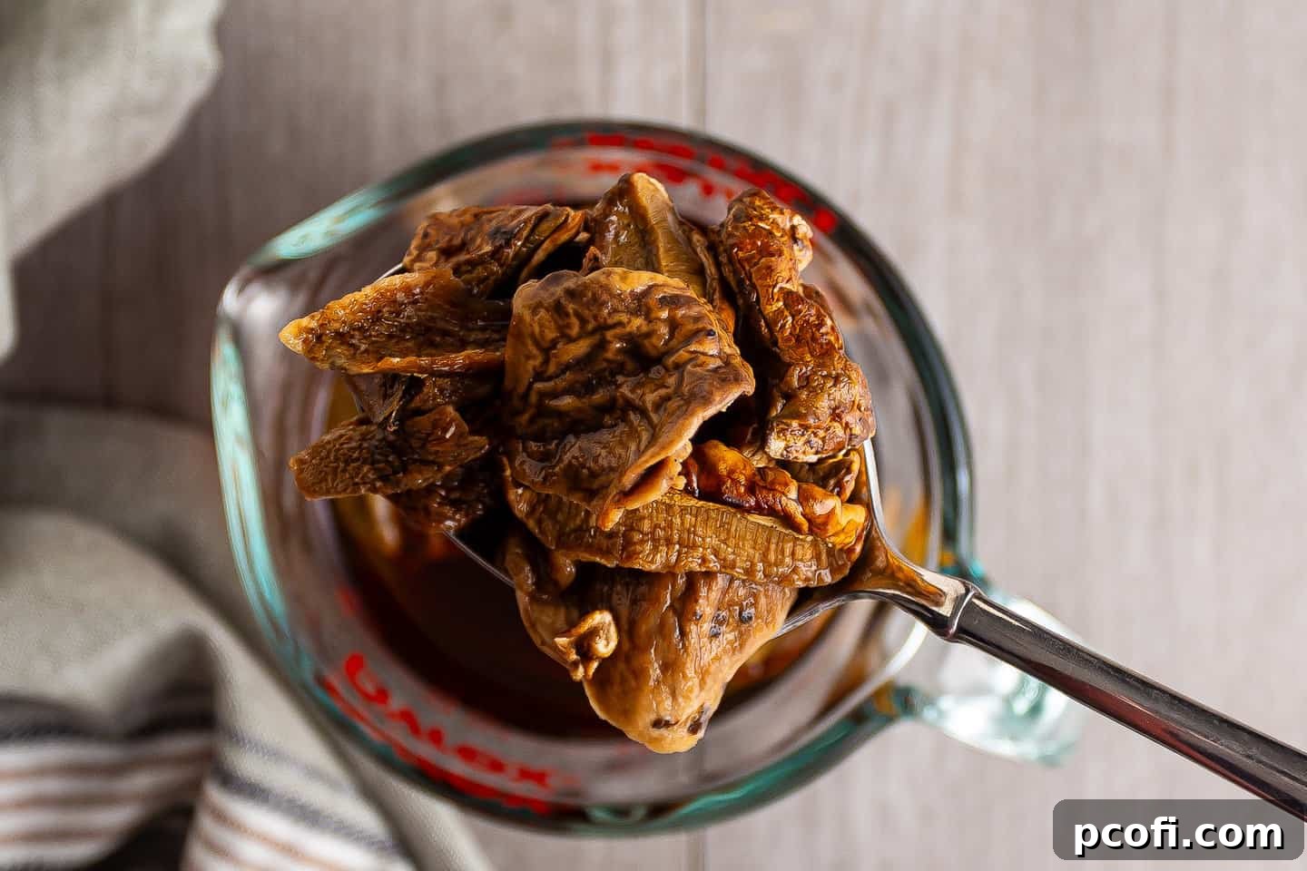 Reconstituted porcini mushrooms, softened and ready for chopping after soaking in hot water.