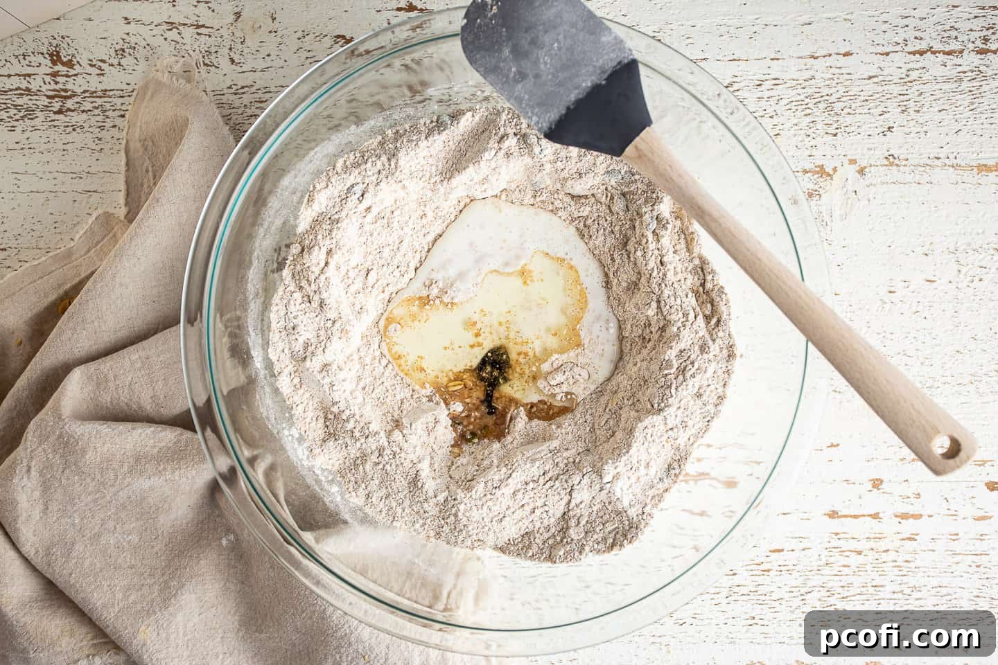 Adding buttermilk, oil, and molasses to the dry ingredients.