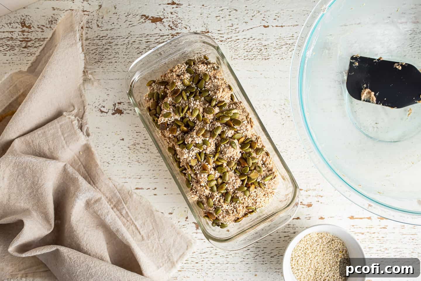 Unbaked Irish brown bread in a glass loaf pan.