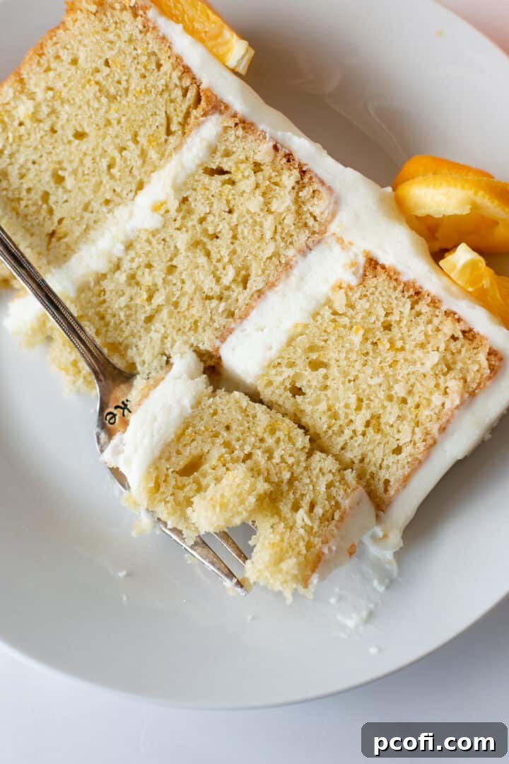 Close-up of the orange creamsicle cake layers and smooth cream cheese frosting.