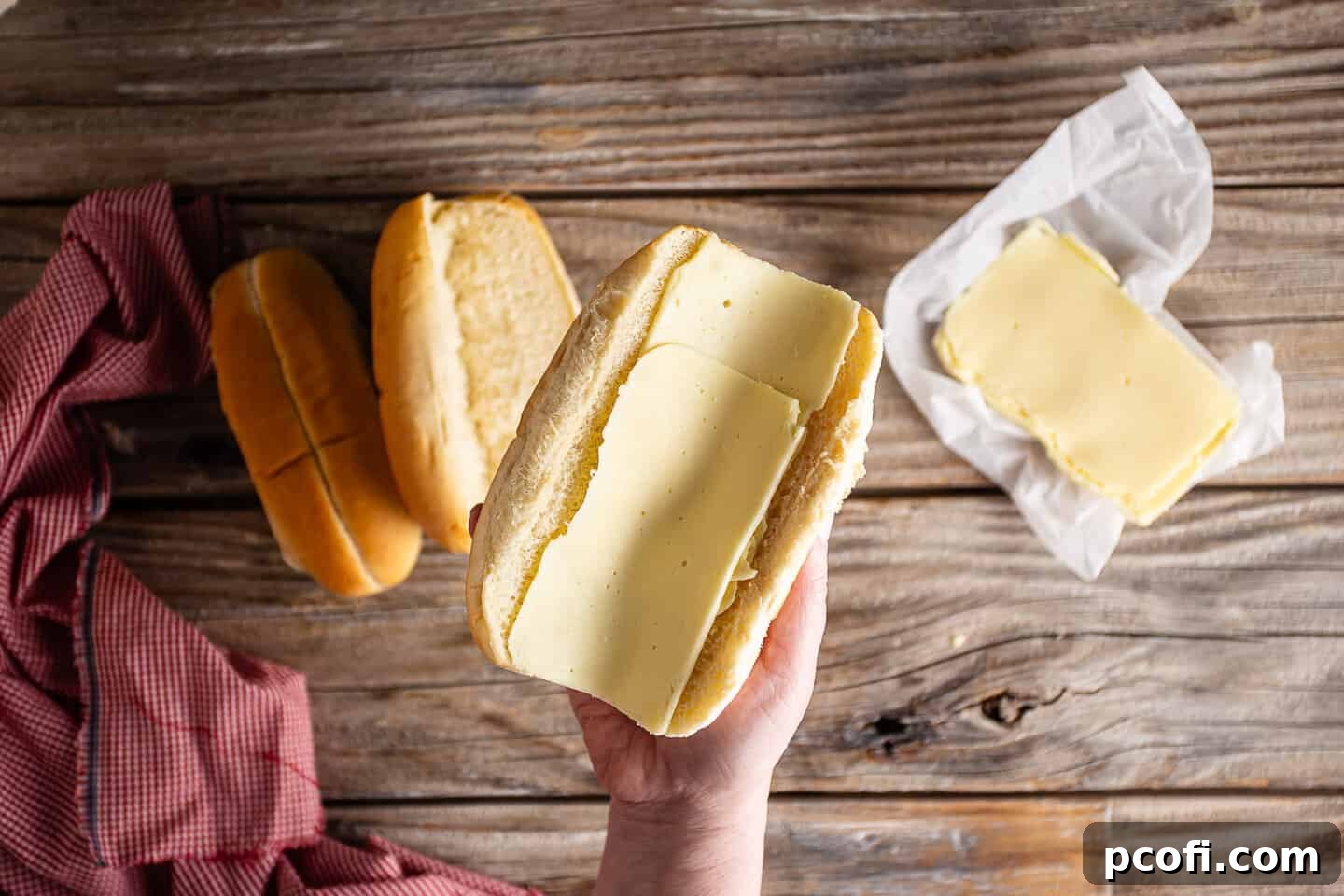 Lining inside a steak roll with cheese.