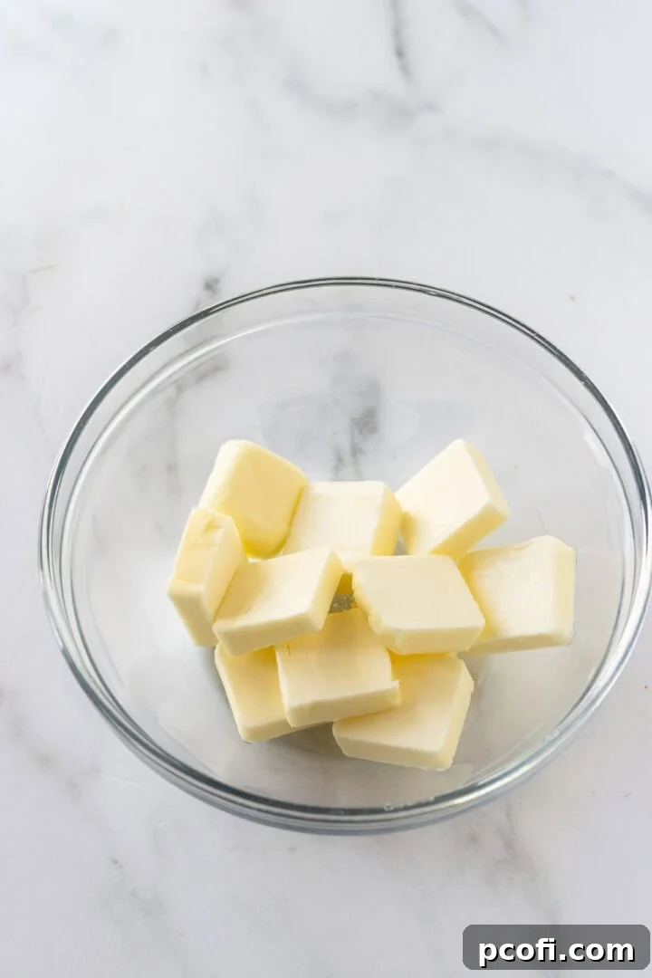 A stick of butter in a microwave-safe dish, ready for softening with controlled bursts of heat.