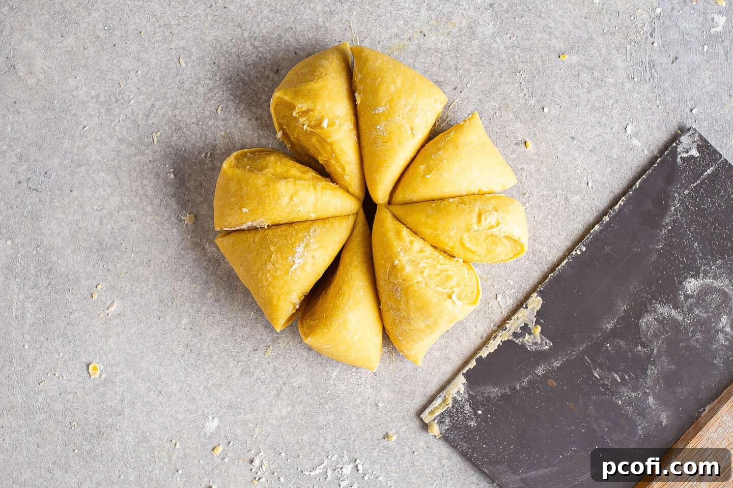 Dividing pasta dough into eighths, preparing for rolling with a pasta machine.
