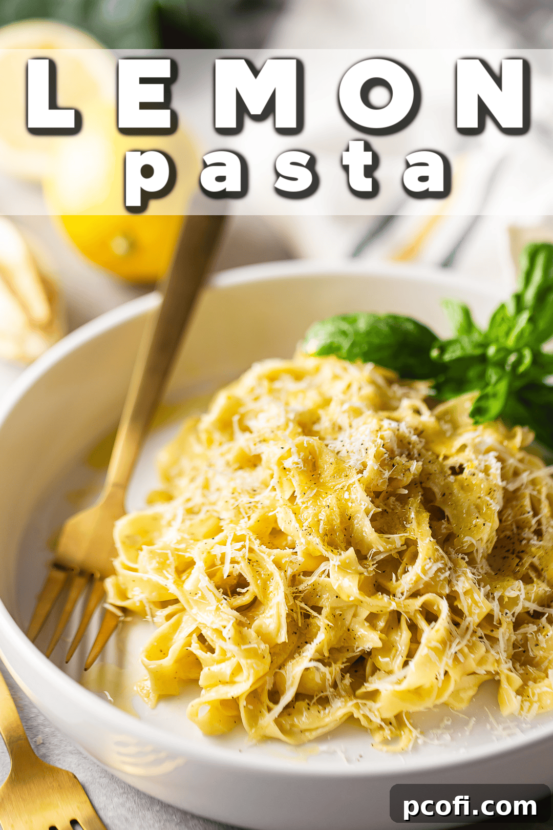 A close-up shot of creamy lemon pasta, beautifully prepared and served in a shallow ceramic bowl, with a gold fork resting alongside. The light reflects off the glistening sauce, highlighting the rich texture and fresh ingredients.