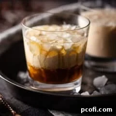 White Russian cocktail in a low ball glass with crushed ice.