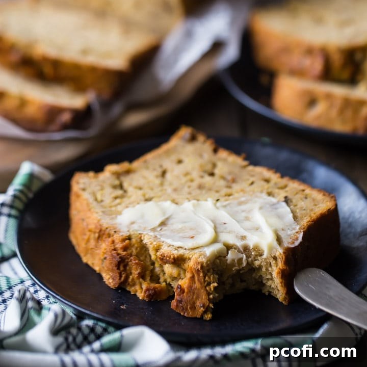 Best Zucchini Bread Recipe, a freshly baked loaf with a crumbly top.