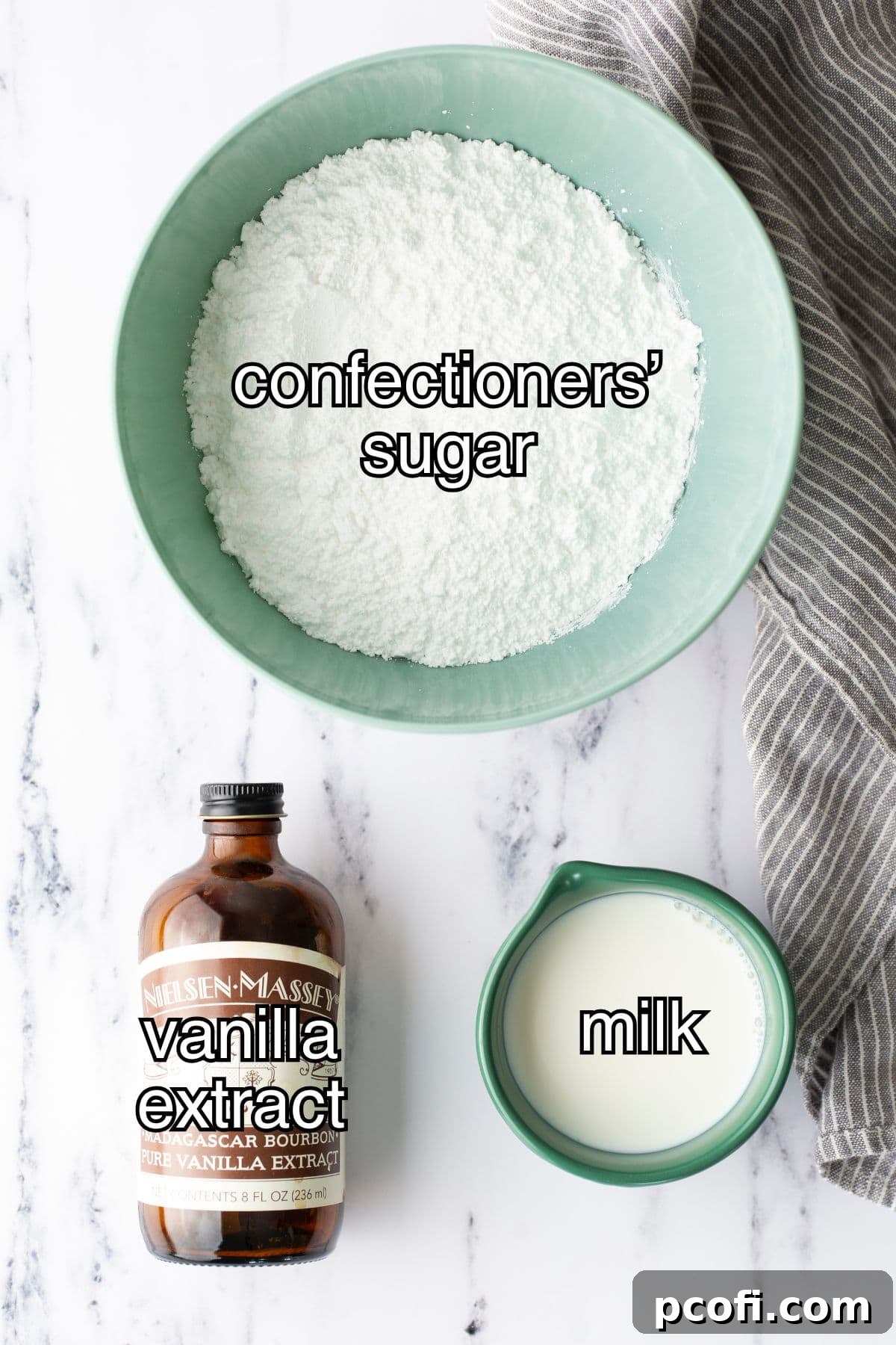 A collection of essential ingredients for making vanilla icing, neatly arranged on a surface.