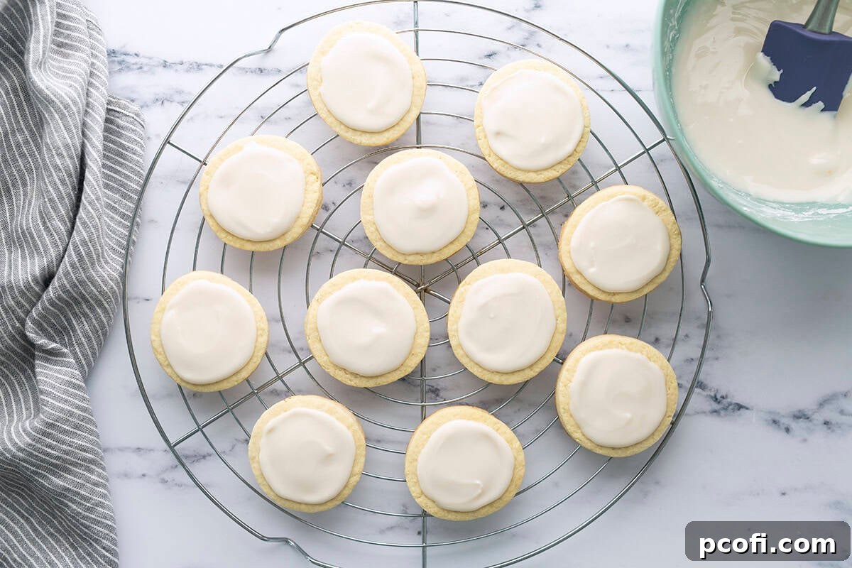 Delicious sugar cookies beautifully topped with a smooth, sweet vanilla icing drizzle.