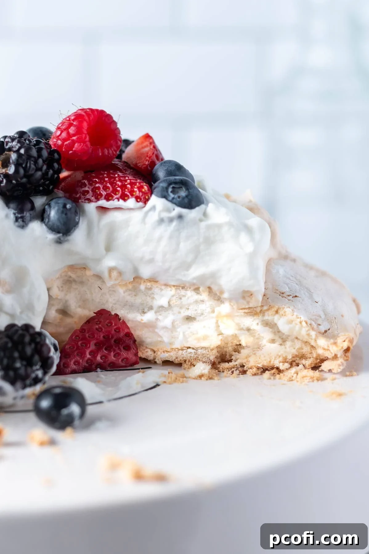 cut pavlova on a cake stand showing soft center