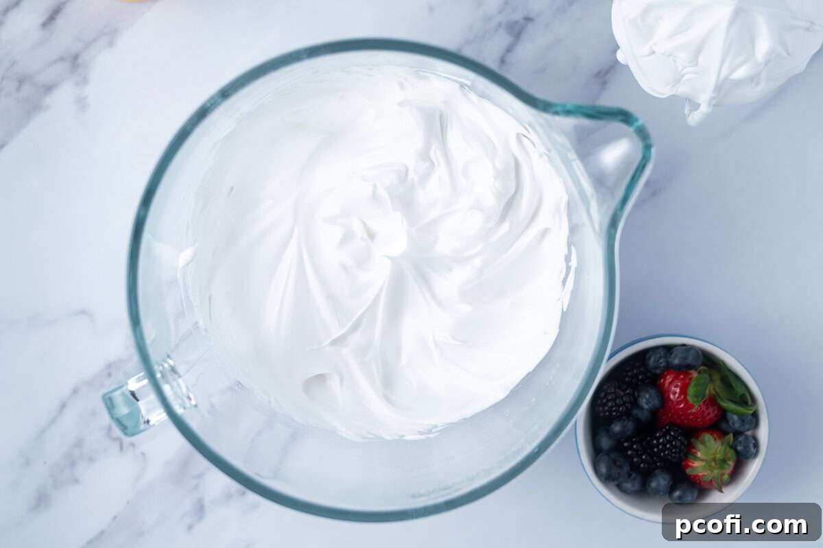 meringue whipped to stiff peaks in a mixing bowl