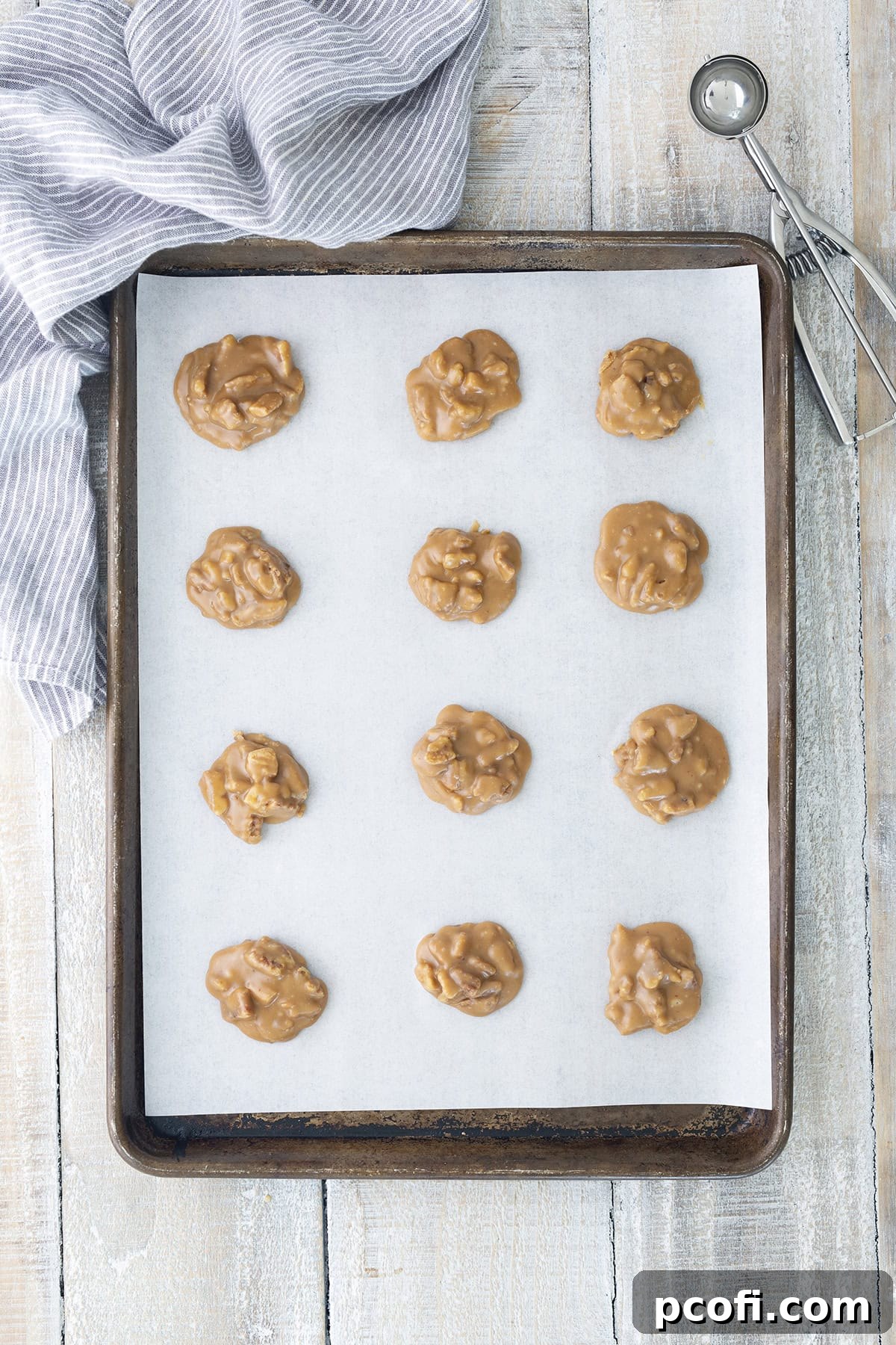 Pralines scooped onto a sheet pan for cooling