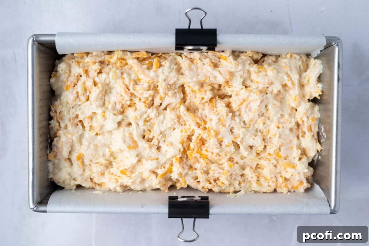quick bread batter in a parchment lined loaf pan