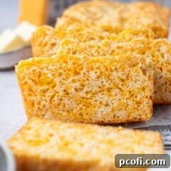 slices of cheese bread on a cooling rack with butter in the background