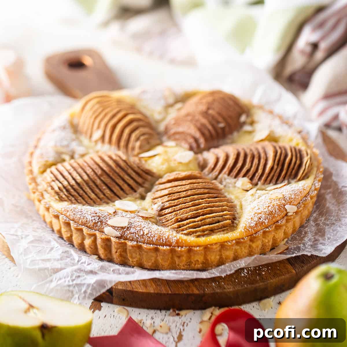 Beautifully arranged sliced pears on a golden baked tart.