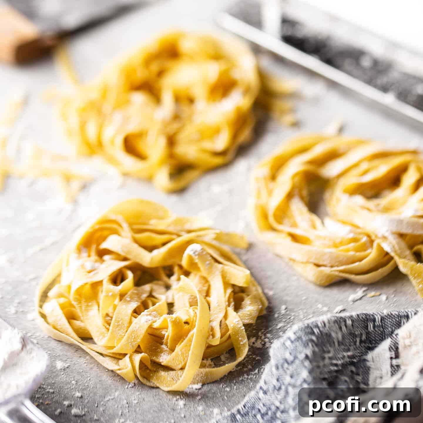 Homemade pasta dough, expertly prepared and cut into delicate ribbons, ready for cooking.