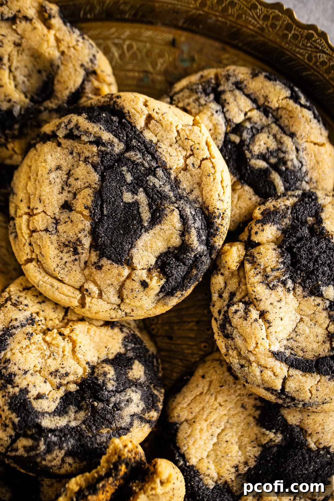 A close-up shot of a platter filled with freshly baked Black Sesame Earl Grey cookies, highlighting their texture and swirls.