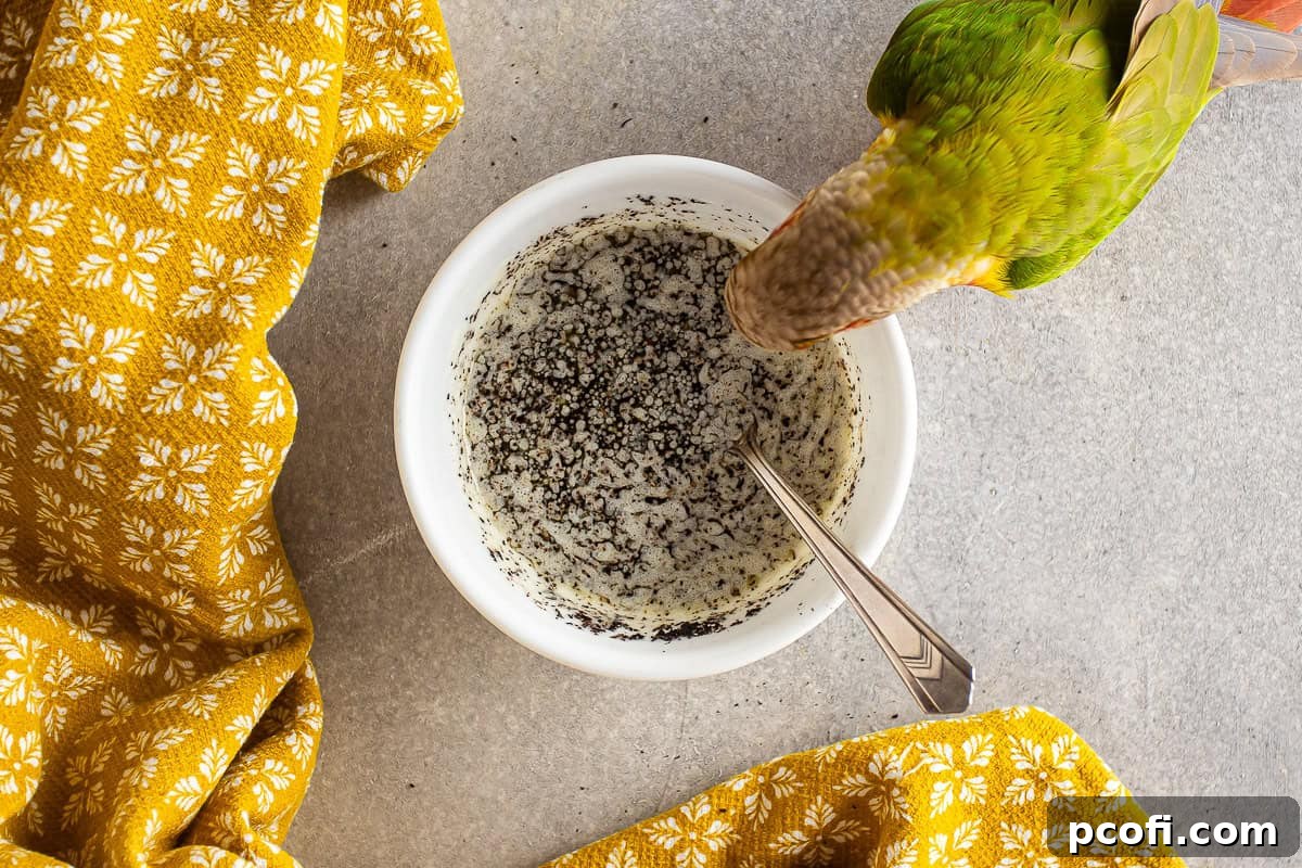 Close-up of Earl Grey infused butter in a bowl, with a small bird playfully peeking over the edge.