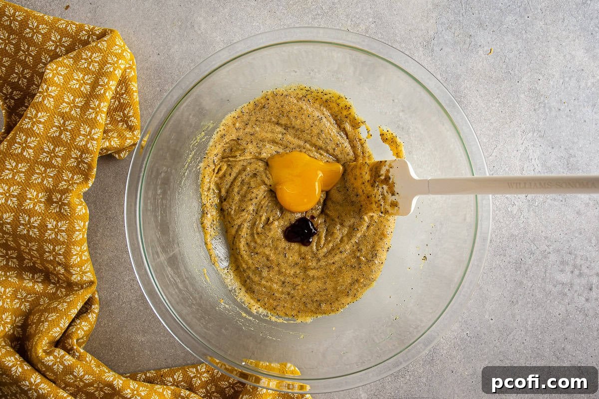 Another image of an egg yolk being incorporated into the Earl Grey cookie dough mixture.