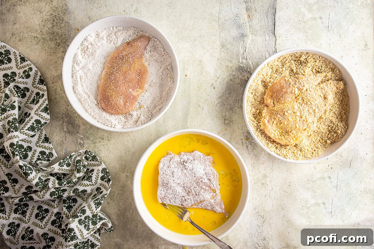 Breading chicken cutlets before frying.