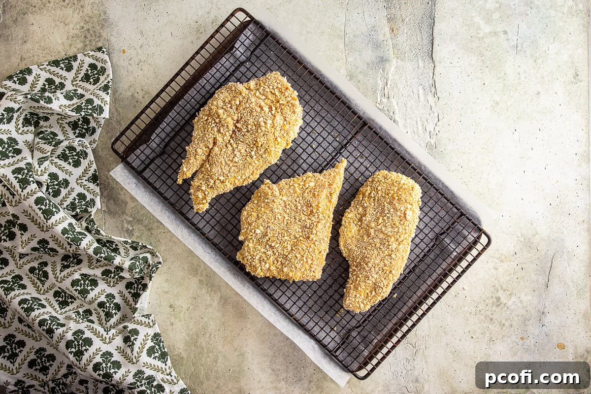 Breaded chicken cutlets on a rack.