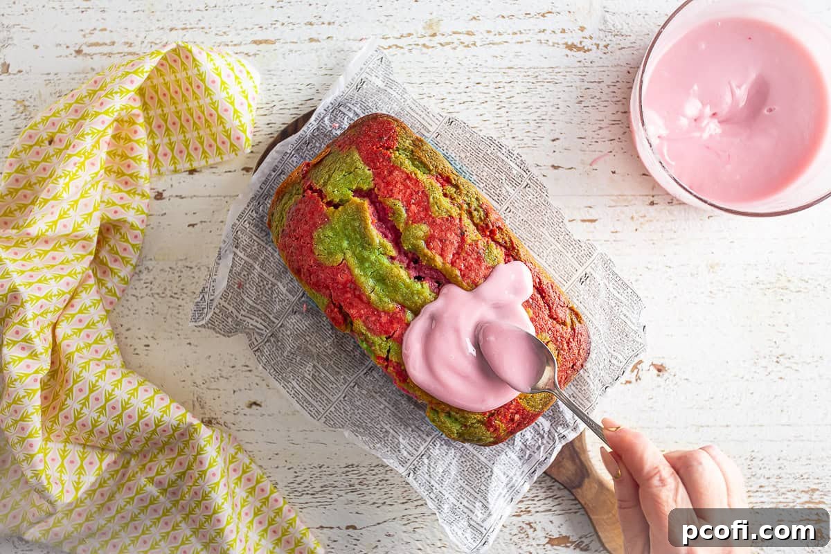 Drizzling strawberry icing over the cooled Strawberry Matcha Loaf.